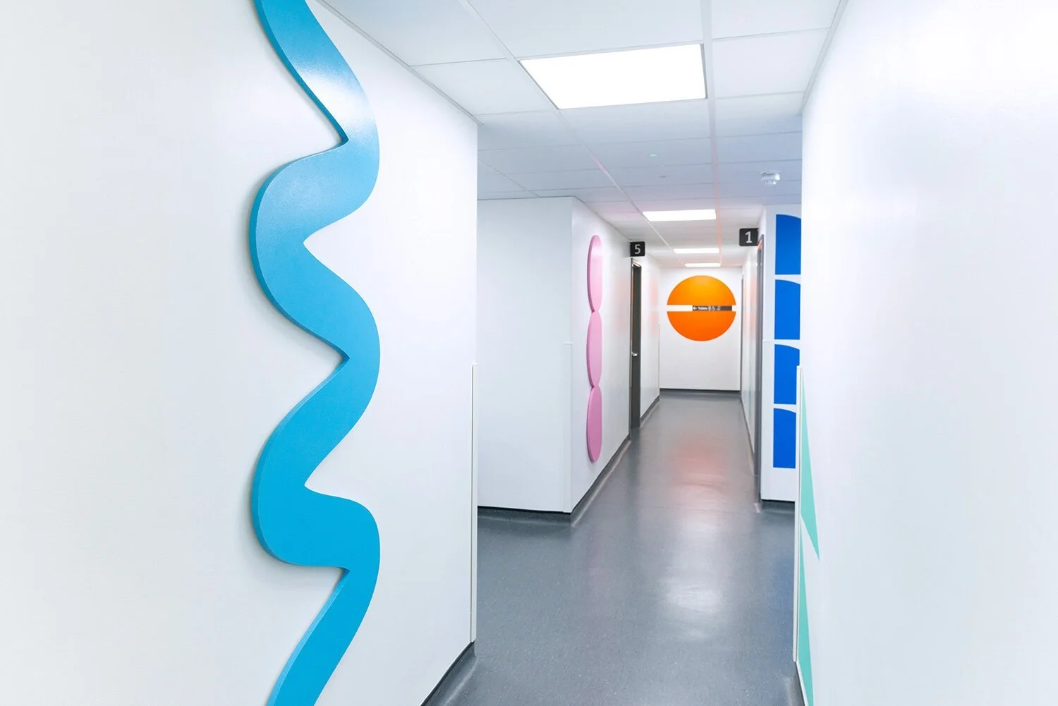 Blue sculptural landmark leading through a hospital corridor