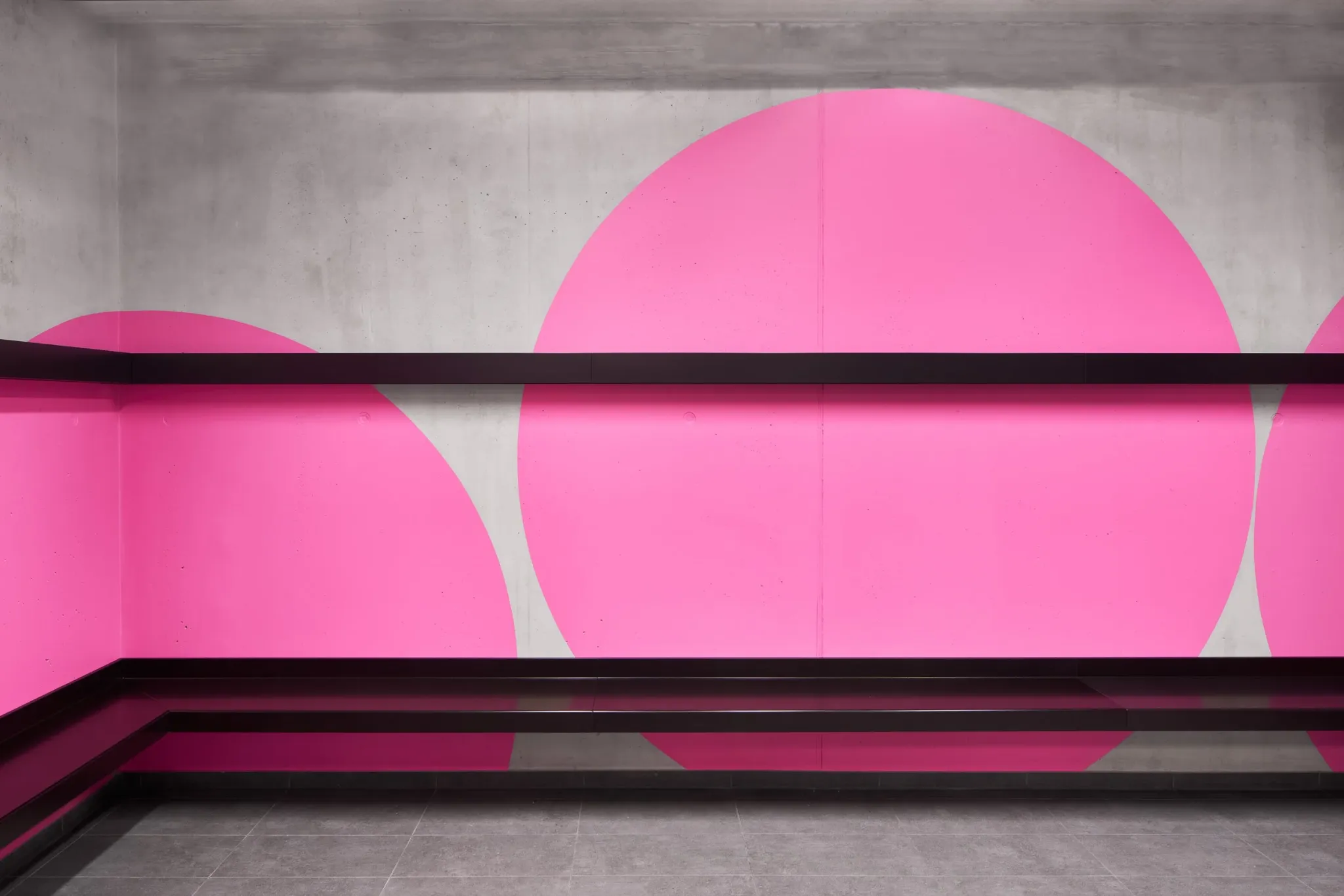 Pink circular forms wrapping around a staircase