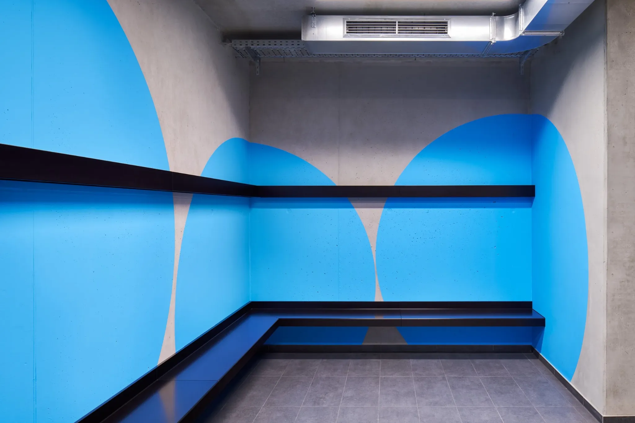 Blue circular forms wrapping around a staircase
