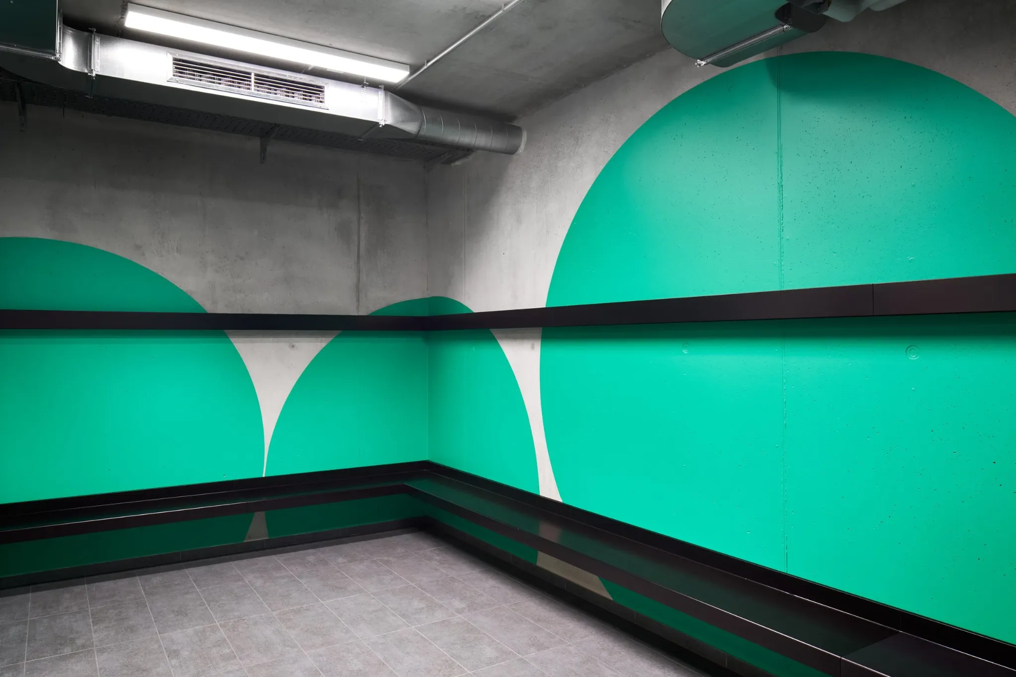 Green circular forms wrapping around a staircase